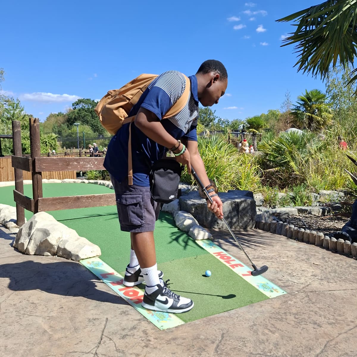 Henry taking his putt on hole seven of the adventure golf course